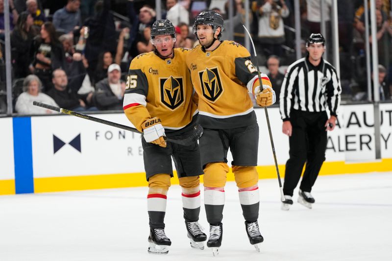 Oct 9, 2024; Las Vegas, Nevada, USA; Vegas Golden Knights right wing Victor Olofsson (95) celebrates with defenseman Shea Theodore (27) after scoring a goal against the Colorado Avalanche during the second period at T-Mobile Arena. Mandatory Credit: Lucas Peltier-Imagn Images