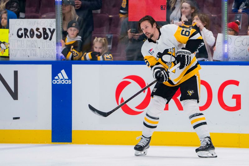 Feb 27, 2024; Vancouver, British Columbia, CAN; Pittsburgh Penguins defenseman Erik Karlsson (65) makes a pass during warm up prior to a game against the Vancouver Canucks at Rogers Arena. Mandatory Credit: Bob Frid-USA TODAY Sports