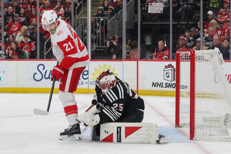Nov 24, 2025; Newark, New Jersey, USA; New Jersey Devils goaltender Jacob Markstrom (25) makes a save through a screen by Detroit Red Wings left wing James van Riemsdyk (21) during the first period at Prudential Center. Mandatory Credit: Ed Mulholland-Imagn Images