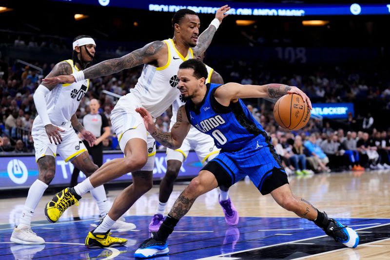 ORLANDO, FLORIDA - FEBRUARY 29: Cole Anthony #50 of the Orlando Magic dribbles the ball against John Collins #20 of the Utah Jazz during the second quarter at Kia Center on February 29, 2024 in Orlando, Florida. NOTE TO USER: User expressly acknowledges and agrees that, by downloading and or using this photograph, user is consenting to the terms and conditions of the Getty Images License Agreement. (Photo by Rich Storry/Getty Images)