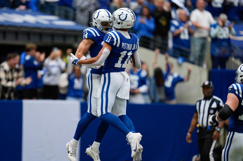 Indianapolis Colts wide receiver Alec Pierce (14) celebrates a touchdown with wide receiver Michael Pittman Jr. (11) during the first half of an NFL football game against the Houston Texans, Sunday, Sept. 8, 2024, in Indianapolis. (AP Photo/Michael Conroy)