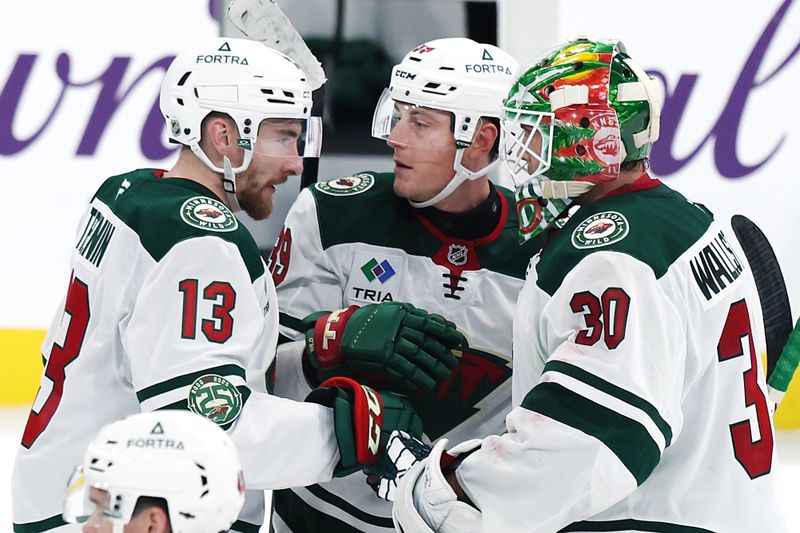 Sep 21, 2025; Winnipeg, Manitoba, CAN;Minnesota Wild center Yakov Trenin (13), Minnesota Wild center Ben Jones (39) and Minnesota Wild goaltender Jesper Wallstedt (30) celebrate their win over the Winnipeg Jets at Canada Life Centre. Mandatory Credit: James Carey Lauder-Imagn Images