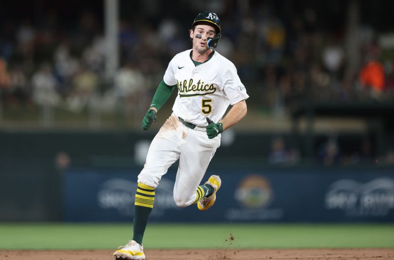 May 5, 2025; West Sacramento, California, USA; Athletics shortstop Jacob Wilson (5) runs to third after a single by Luis Urias (not pictured) against the Seattle Mariners during the sixth inning at Sutter Health Park. Mandatory Credit: Dennis Lee-Imagn Images