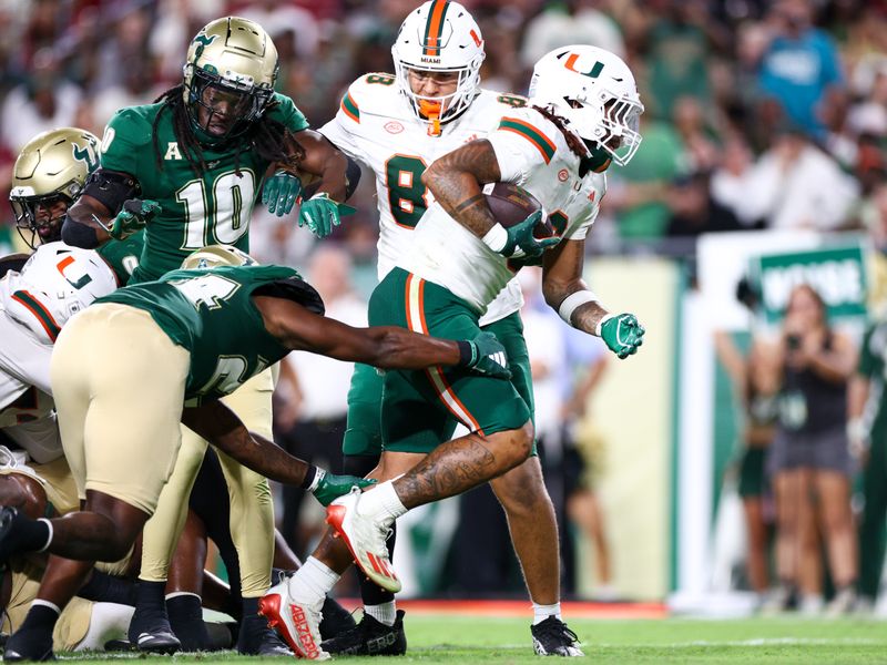 Sep 21, 2024; Tampa, Florida, USA; Miami Hurricanes running back Damien Martinez (6) score a touchdown against the South Florida Bulls in the third quarter at Raymond James Stadium. Mandatory Credit: Nathan Ray Seebeck-Imagn Images