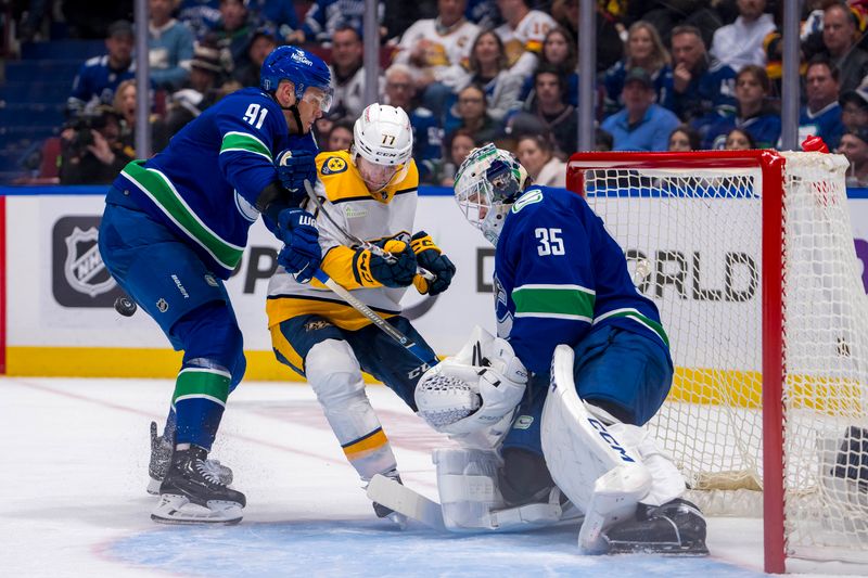 Apr 21, 2024; Vancouver, British Columbia, CAN; Vancouver Canucks goalie Thatcher Demko (35) watches as defenseman Nikita Zadorov (91) checks Nashville Predators forward Luke Evangelista (77) in the second period in game one of the first round of the 2024 Stanley Cup Playoffs at Rogers Arena. Mandatory Credit: Bob Frid-USA TODAY Sports