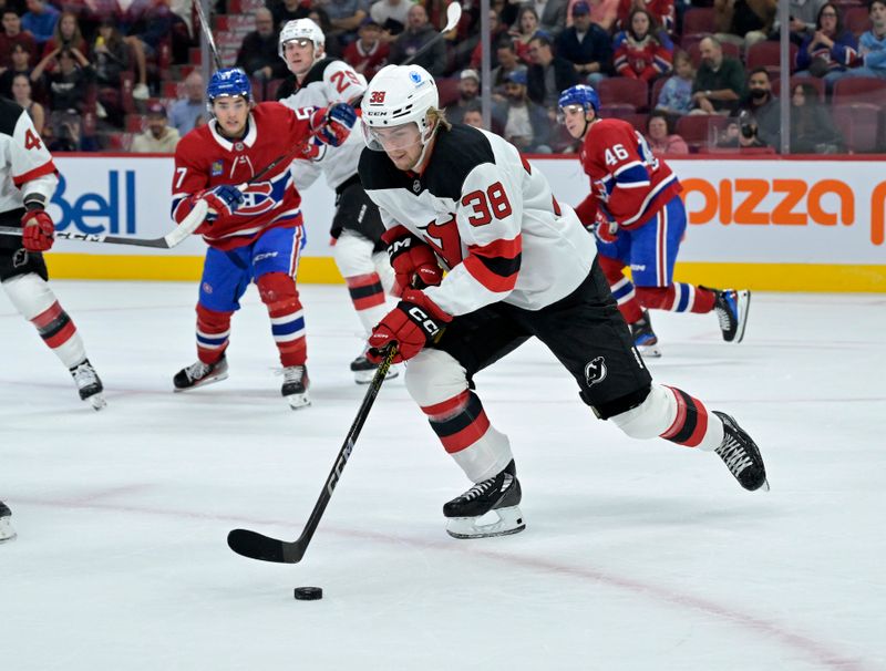 Sep 24, 2024; Montreal, Quebec, CAN; New Jersey Devils defenseman Topias Vilen (38) plays the puck against the Montreal Canadiens during the first period at the Bell Centre. Mandatory Credit: Eric Bolte-Imagn Images