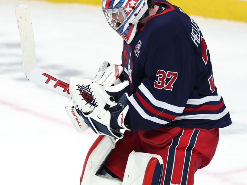 Dec 13, 2025; Winnipeg, Manitoba, CAN; Winnipeg Jets goaltender Connor Hellebuyck (37) celebrates their victory against the Washington Capitals at Canada Life Centre. Mandatory Credit: James Carey Lauder-Imagn Images