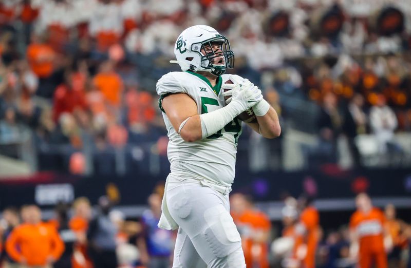 Dec 4, 2021; Arlington, TX, USA; Baylor Bears defensive lineman Brayden Utley (54) reacts after making an interception during the second half against the Oklahoma State Cowboys in the Big 12 Conference championship game at AT&T Stadium. Mandatory Credit: Kevin Jairaj-USA TODAY Sports