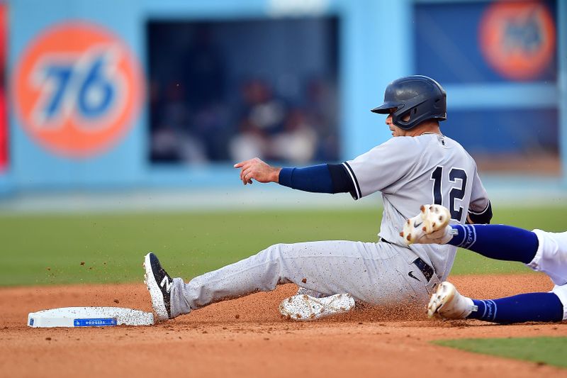 Jun 4, 2023; Los Angeles, California, USA; New York Yankees center fielder Isiah Kiner-Falefa (12) steals second against Los Angeles Dodgers shortstop Chris Taylor (3) during the ninth inning at Dodger Stadium. Mandatory Credit: Gary A. Vasquez-USA TODAY Sports