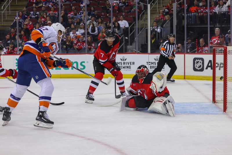 Oct 25, 2024; Newark, New Jersey, USA; New York Islanders left wing Anders Lee (27) scores a goal on New Jersey Devils goaltender Jake Allen (34) during the first period at Prudential Center. Mandatory Credit: Ed Mulholland-Imagn Images