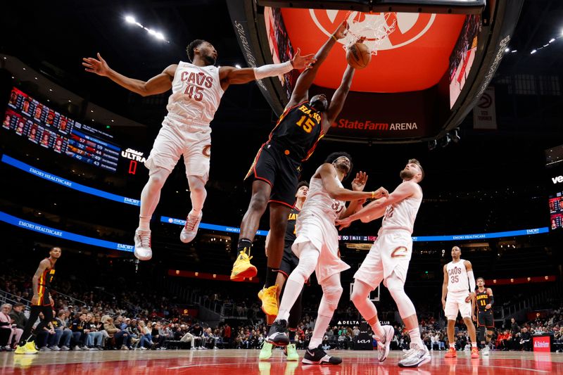 ATLANTA, GEORGIA - JANUARY 20: Clint Capela #15 of the Atlanta Hawks dunks the ball over Donovan Mitchell #45 of the Cleveland Cavaliers during the second half at State Farm Arena on January 20, 2024 in Atlanta, Georgia. NOTE TO USER: User expressly acknowledges and agrees that, by downloading and or using this photograph, User is consenting to the terms and conditions of the Getty Images License Agreement. (Photo by Alex Slitz/Getty Images)