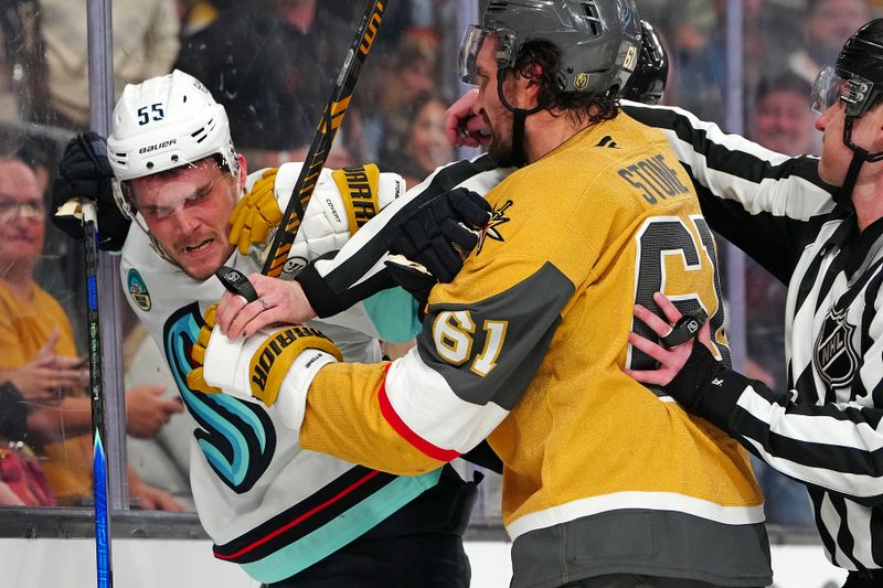 Jan 31, 2026; Las Vegas, Nevada, USA; Vegas Golden Knights right wing Mark Stone (61) grabs Seattle Kraken defenseman Ryan Lindgren (55) during the third period at T-Mobile Arena. Mandatory Credit: Stephen R. Sylvanie-Imagn Images
