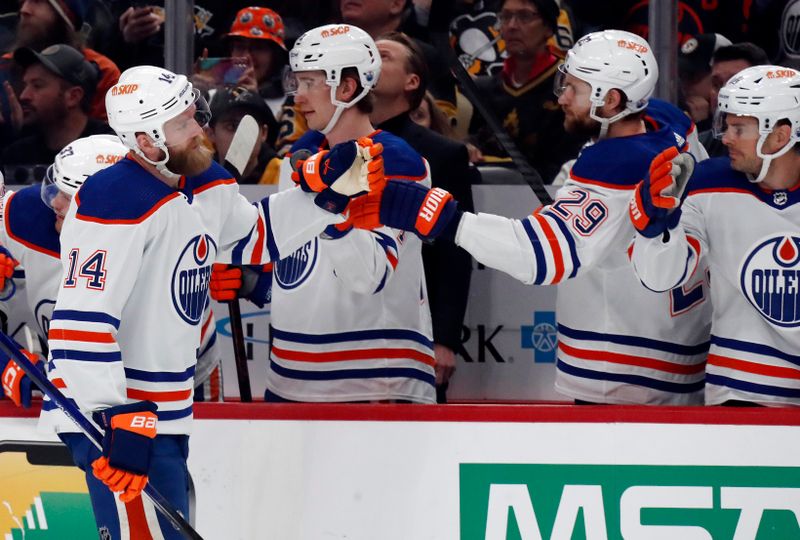 Mar 10, 2024; Pittsburgh, Pennsylvania, USA;  Edmonton Oilers defenseman Mattias Ekholm (14) celebrates with the Oilers bench after scoring a goal against the Pittsburgh Penguins during the first period at PPG Paints Arena. Mandatory Credit: Charles LeClaire-USA TODAY Sports