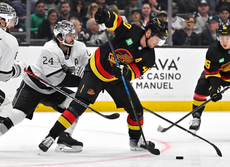 Apr 10, 2023; Los Angeles, California, USA;  Los Angeles Kings center Phillip Danault (24) and Vancouver Canucks center Elias Pettersson (40) go for the puck in the first period at Crypto.com Arena. Mandatory Credit: Jayne Kamin-Oncea-USA TODAY Sports