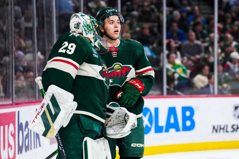 Jan 15, 2024; Saint Paul, Minnesota, USA; Minnesota Wild goaltender Marc-Andre Fleury (29) talks with defenseman Brock Faber (7) during the first period against the New York Islanders at Xcel Energy Center. Mandatory Credit: Brace Hemmelgarn-USA TODAY Sports