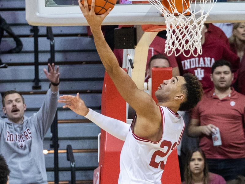 Jan 14, 2023; Bloomington, Indiana, USA; Indiana Hoosiers forward Trayce Jackson-Davis (23) shoots the ball while Wisconsin Badgers guard Max Klesmit (11) defends in the second half at Simon Skjodt Assembly Hall. Mandatory Credit: Trevor Ruszkowski-USA TODAY Sports