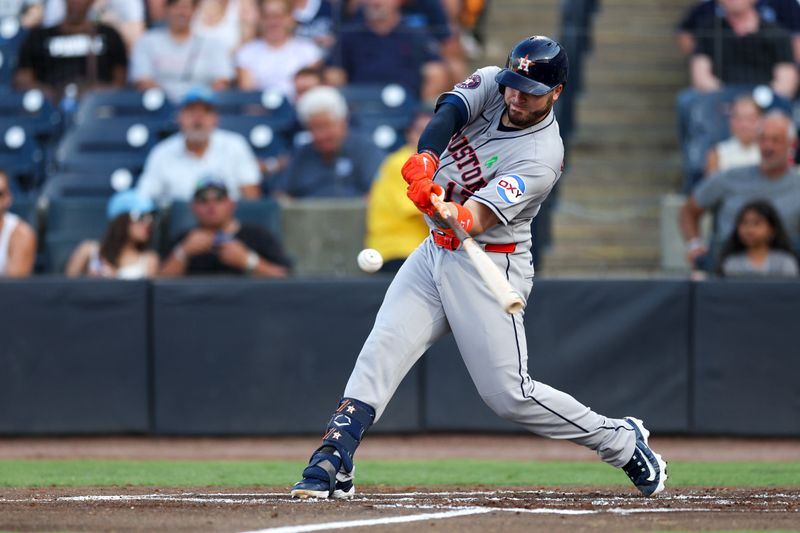 May 19, 2025; Tampa, Florida, USA; Houston Astros catcher Victor Caratini (17) hits a home run against the Tampa Bay Rays in the second inning at George M. Steinbrenner Field. Mandatory Credit: Nathan Ray Seebeck-Imagn Images