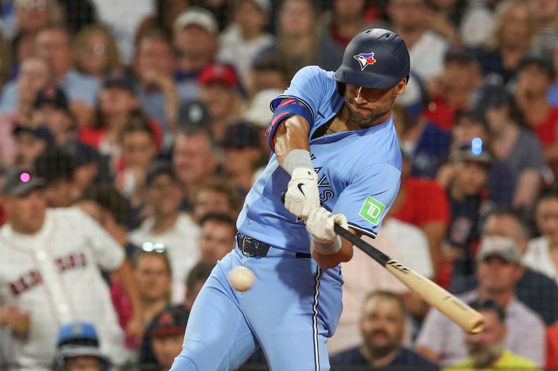 Jun 24, 2024; Boston, Massachusetts, USA; Toronto Blue Jays center fielder Kevin Kiermaier (39) hits an RBI during the seventh inning against the Boston Red Sox at Fenway Park. Mandatory Credit: Paul Rutherford-USA TODAY Sports