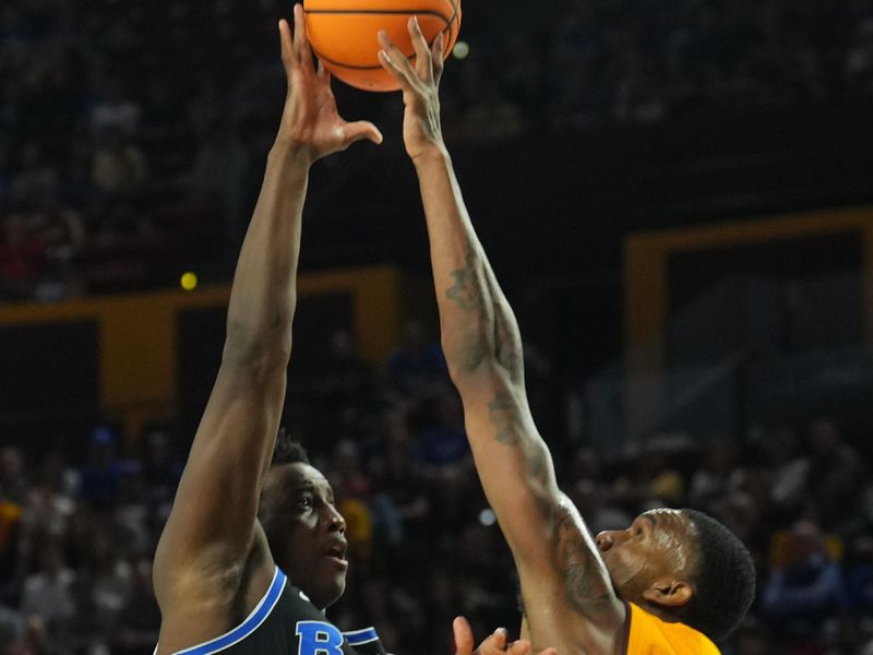 Feb 26, 2025; Tempe, Arizona, USA; Arizona State Sun Devils center Shawn Phillips Jr. (9) blocks a shot by Brigham Young Cougars center Fousseyni Traore (45) during the second half at Desert Financial Arena. Mandatory Credit: Joe Camporeale-Imagn Images