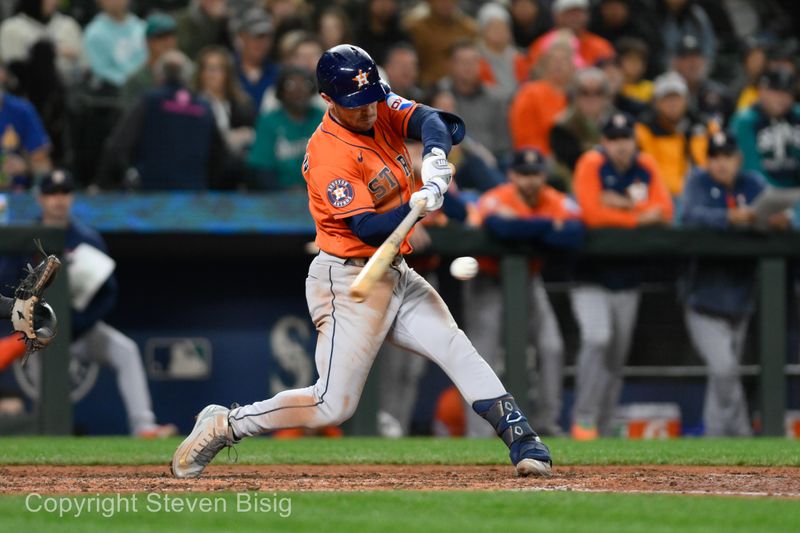 Sep 27, 2023; Seattle, Washington, USA; Houston Astros third baseman Alex Bregman (2) hits a triple against the Seattle Mariners during the seventh inning at T-Mobile Park. Mandatory Credit: Steven Bisig-USA TODAY Sports