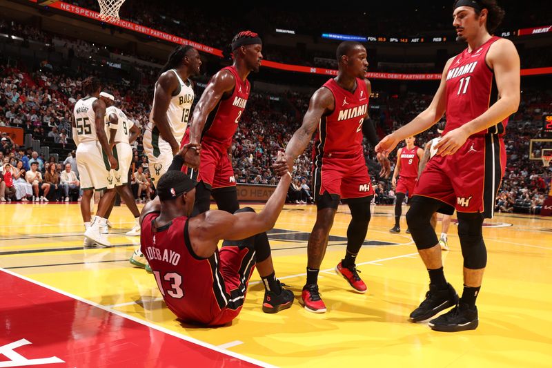 MIAMI, FL - NOVEMBER 26: Jimmy Butler #22 and Terry Rozier #2 help up Bam Adebayo #13 of the Miami Heat during the game against the Milwaukee Bucks during the Emirates NBA Cup game on November 26, 2024 at Kaseya Center in Miami, Florida. NOTE TO USER: User expressly acknowledges and agrees that, by downloading and or using this Photograph, user is consenting to the terms and conditions of the Getty Images License Agreement. Mandatory Copyright Notice: Copyright 2024 NBAE (Photo by Issac Baldizon/NBAE via Getty Images)