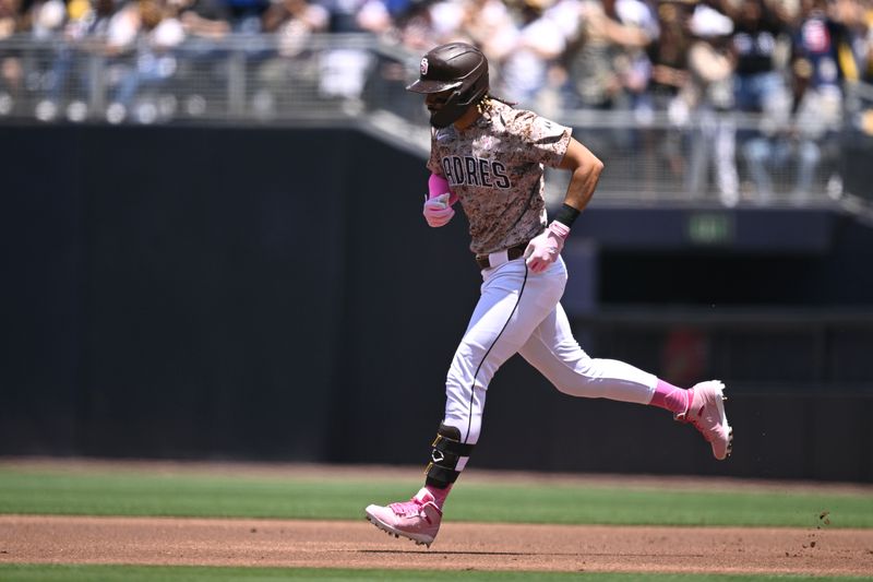 May 12, 2024; San Diego, California, USA; San Diego Padres right fielder Fernando Tatis Jr. (23) rounds the bases after hitting a home run against the Los Angeles Dodgers during the first inning at Petco Park. Mandatory Credit: Orlando Ramirez-USA TODAY Sports