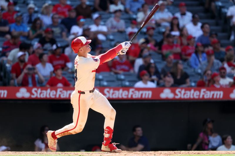 Jun 9, 2024; Anaheim, California, USA;  Los Angeles Angels catcher Logan O'Hoppe (14) hits a game winning 2-run home run in bottom of the ninth inning against the Houston Astros at Angel Stadium. Mandatory Credit: Kiyoshi Mio-USA TODAY Sports