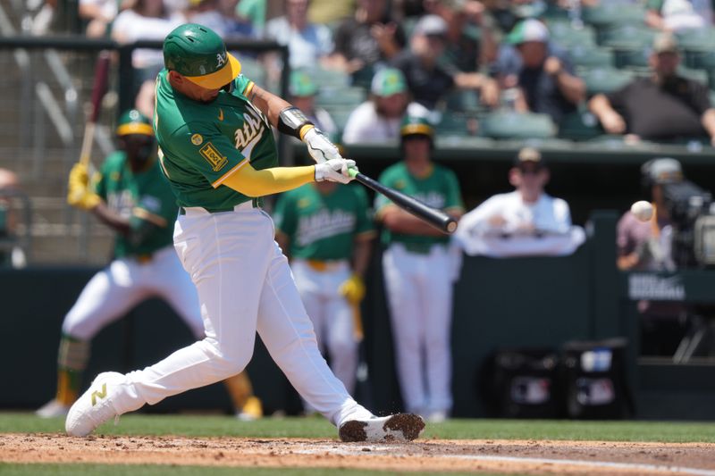 Jun 8, 2025; West Sacramento, California, USA; Athletics catcher Jhonny Pereda (64) hits an RBI double against the Baltimore Orioles during the second inning at Sutter Health Park. Mandatory Credit: Darren Yamashita-Imagn Images