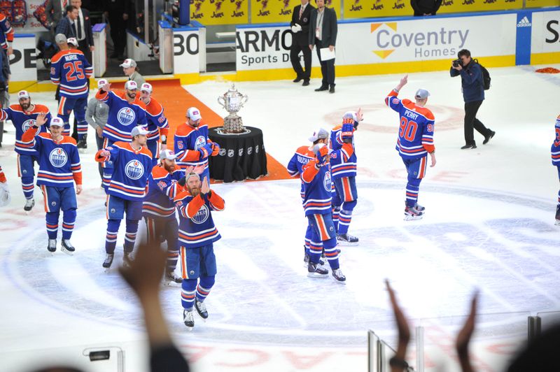 Jun 2, 2024; Edmonton, Alberta, CAN; Edmonton Oilers players pose with the Western Conference trophy at the end of the third period in game six of the Western Conference Final of the 2024 Stanley Cup Playoffs at Rogers Place. Mandatory Credit: Walter Tychnowicz-USA TODAY Sports