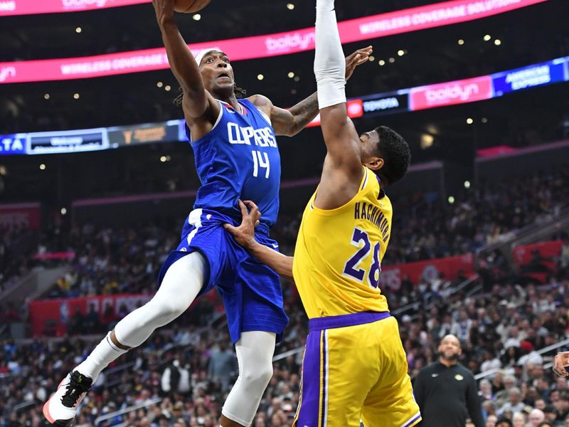 LOS ANGELES, CA - JANUARY 23:  Terance Mann #14 of the LA Clippers goes to the basket during the game on January 23, 2024 at Crypto.Com Arena in Los Angeles, California. NOTE TO USER: User expressly acknowledges and agrees that, by downloading and/or using this Photograph, user is consenting to the terms and conditions of the Getty Images License Agreement. Mandatory Copyright Notice: Copyright 2024 NBAE (Photo by Juan Ocampo/NBAE via Getty Images)