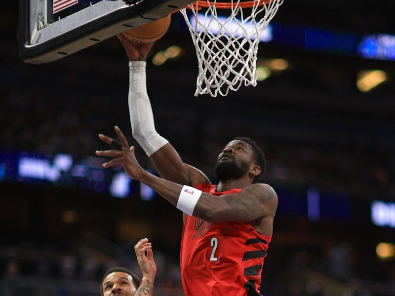 ORLANDO, FLORIDA - APRIL 01: Deandre Ayton #2 of the Portland Trail Blazers drives on  Cole Anthony #50 of the Orlando Magic during a game  at Kia Center on April 01, 2024 in Orlando, Florida. NOTE TO USER: User expressly acknowledges and agrees that, by downloading and or using this photograph, User is consenting to the terms and conditions of the Getty Images License Agreement. (Photo by Mike Ehrmann/Getty Images)