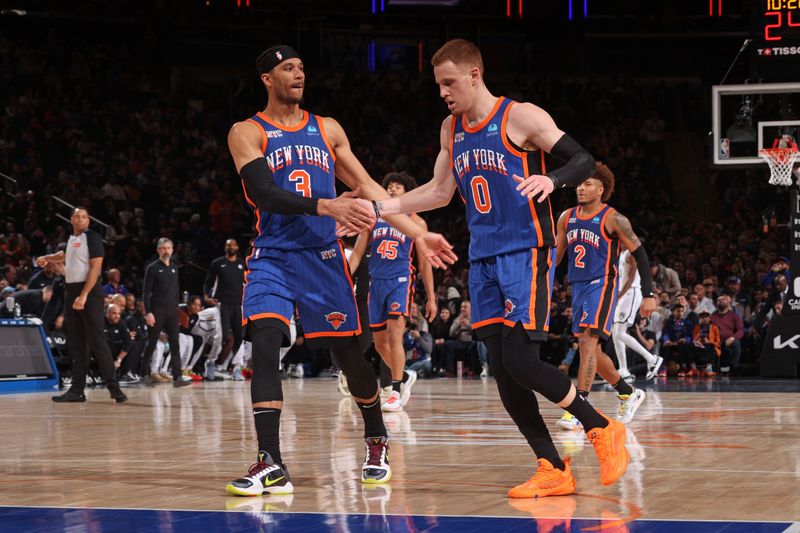 NEW YORK, NY - MARCH 23: Josh Hart #3 and Donte Divincenzo #0 of the New York Knicks high five during the game against the Brooklyn Nets on March 23, 2024 at Madison Square Garden in New York City, New York.  NOTE TO USER: User expressly acknowledges and agrees that, by downloading and or using this photograph, User is consenting to the terms and conditions of the Getty Images License Agreement. Mandatory Copyright Notice: Copyright 2024 NBAE  (Photo by Nathaniel S. Butler/NBAE via Getty Images)