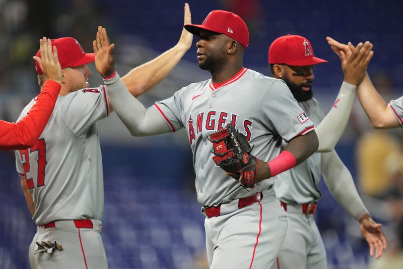 Apr 3, 2024; Miami, Florida, USA; Los Angeles Angels first baseman Miguel Sano (22) celebrates a victory against the Miami Marlins at loanDepot Park. Mandatory Credit: Jim Rassol-USA TODAY Sports