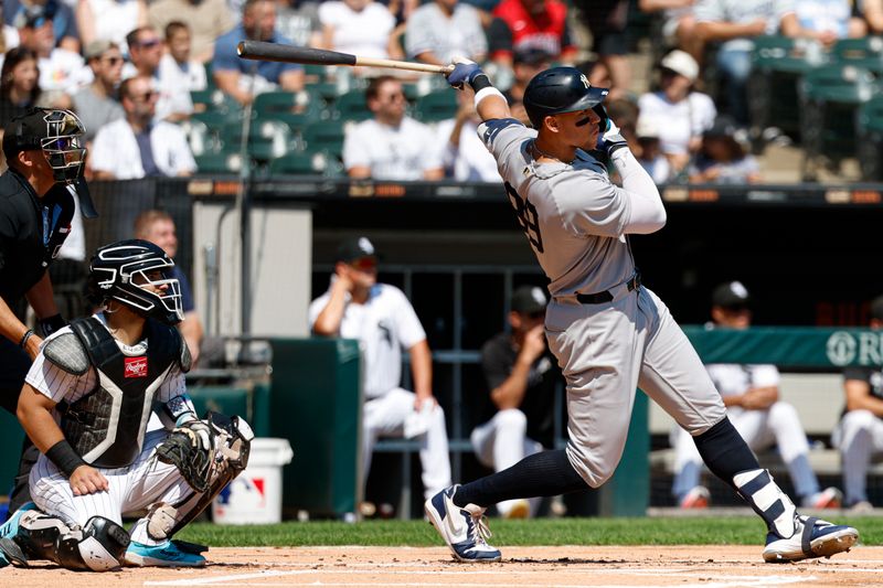 Aug 31, 2025; Chicago, Illinois, USA; New York Yankees designated hitter Aaron Judge (99) hits a solo home run against the Chicago White Sox during the first inning at Rate Field. Mandatory Credit: Kamil Krzaczynski-Imagn Images