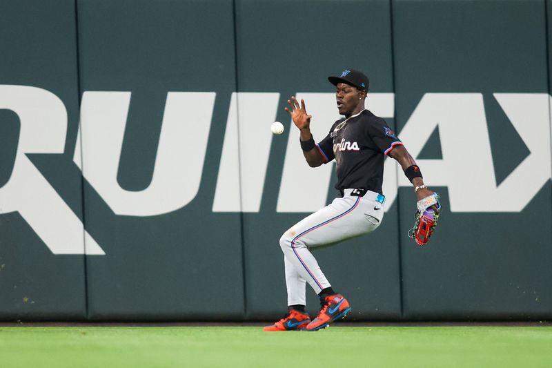 Apr 24, 2024; Atlanta, Georgia, USA; Miami Marlins center fielder Jazz Chisholm Jr. (2) fields a ball against the Atlanta Braves in the tenth inning at Truist Park. Mandatory Credit: Brett Davis-USA TODAY Sports