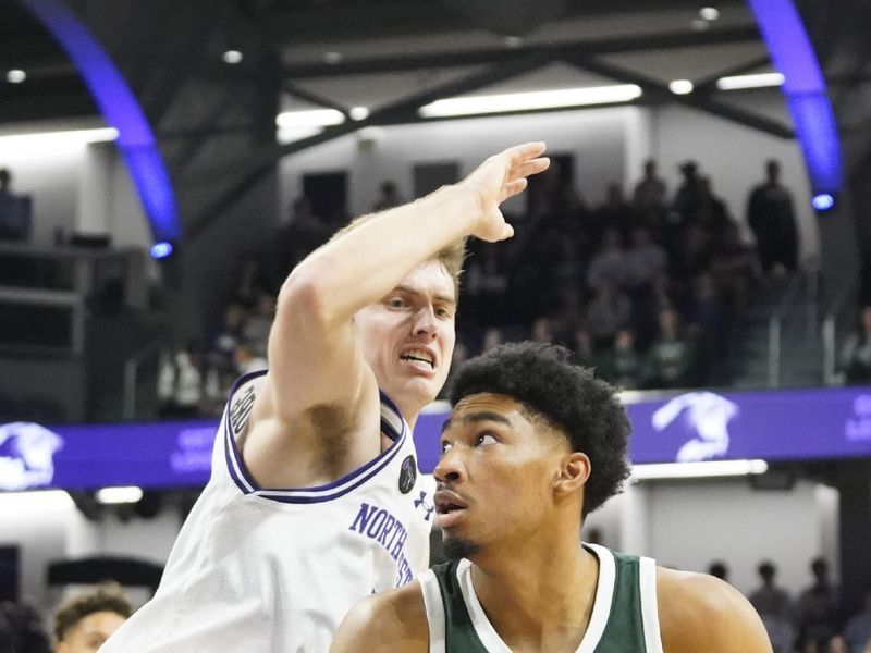 Jan 7, 2024; Evanston, Illinois, USA; Northwestern Wildcats guard Brooks Barnhizer (13) defends Michigan State Spartans forward Malik Hall (25) during the first half at Welsh-Ryan Arena. Mandatory Credit: David Banks-USA TODAY Sports