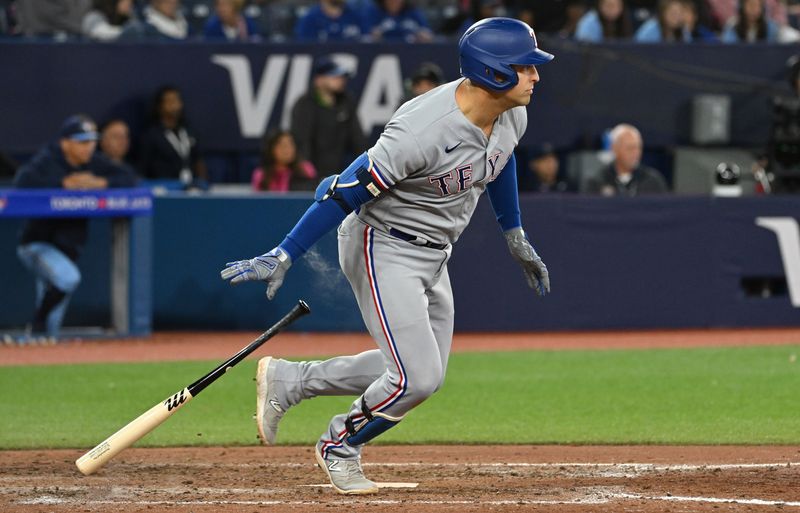 Sep 14, 2023; Toronto, Ontario, CAN;   Texas Rangers first baseman Nathan Lowe (30) hits a two RBI single against the Toronto Blue Jays in the eighth inning at Rogers Centre. Mandatory Credit: Dan Hamilton-USA TODAY Sports