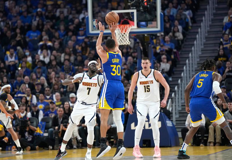 SAN FRANCISCO, CALIFORNIA - FEBRUARY 25: Stephen Curry #30 of the Golden State Warriors shoots a three-point shot over Reggie Jackson #7 of the Denver Nuggets during the first quarter of an NBA basketball game at Chase Center on February 25, 2024 in San Francisco, California. NOTE TO USER: User expressly acknowledges and agrees that, by downloading and or using this photograph, User is consenting to the terms and conditions of the Getty Images License Agreement. (Photo by Thearon W. Henderson/Getty Images)