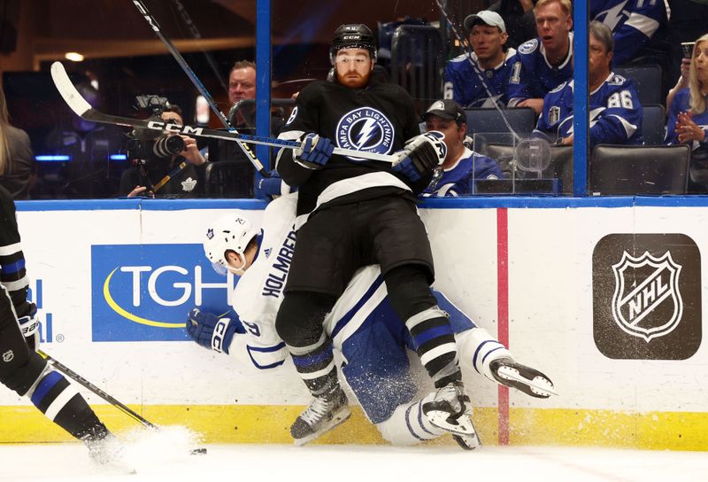 Apr 17, 2024; Tampa, Florida, USA; Tampa Bay Lightning defenseman Nick Perbix (48) denfends Toronto Maple Leafs right wing Pontus Holmberg (29) during the second period at Amalie Arena. Mandatory Credit: Kim Klement Neitzel-USA TODAY Sports