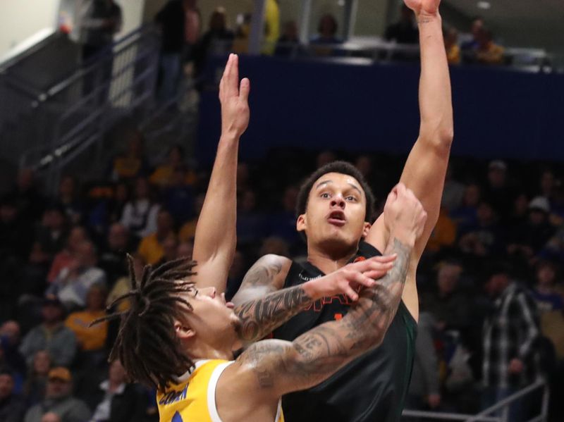 Feb 15, 2025; Pittsburgh, Pennsylvania, USA; Miami (Fl) Hurricanes center Lynn Kidd (right) shoots against Pittsburgh Panthers forward Cameron Corhen (2) during the second half at the Petersen Events Center. Mandatory Credit: Charles LeClaire-Imagn Images