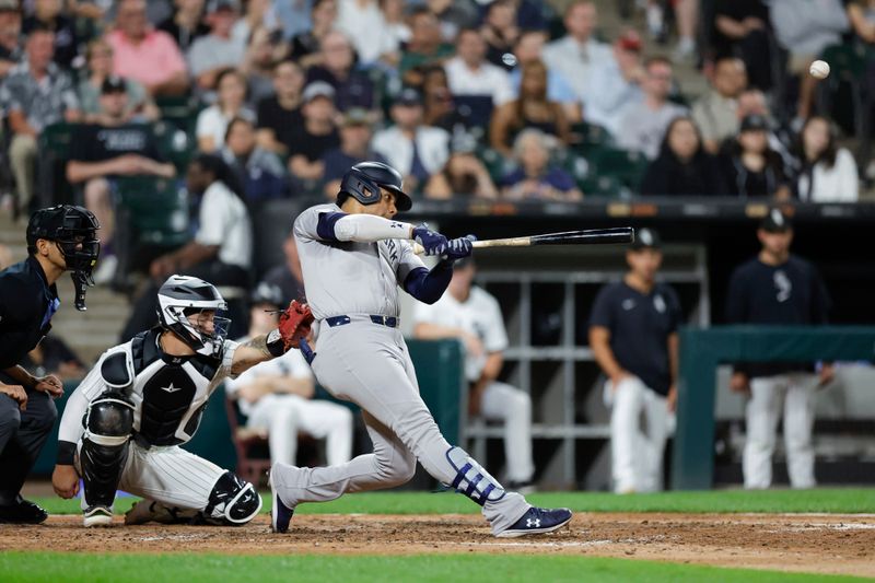 Aug 13, 2024; Chicago, Illinois, USA; New York Yankees outfielder Juan Soto (22) hits a solo home run against the Chicago White Sox during the seventh inning at Guaranteed Rate Field. Mandatory Credit: Kamil Krzaczynski-USA TODAY Sports