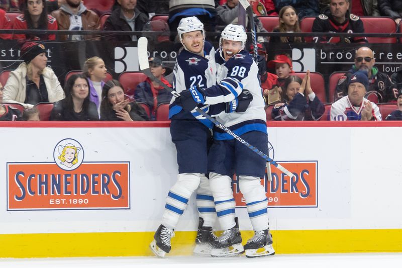 Jan 20, 2024; Ottawa, Ontario, CAN; Winnipeg Jets center Mason Appleton (22) celebrates his goal with center Nate Schmidt (88) in the second period against the Ottawa Senators at the Canadian Tire Centre. Mandatory Credit: Marc DesRosiers-USA TODAY Sports