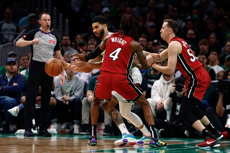 BOSTON, MA - APRIL 21: Jayson Tatum #0 of the Boston Celtics looks for a way around a double team of Delon Wright #4 of the Miami Heat and Duncan Robinson #55 during the first quarter of game one of the Eastern Conference First Round Playoffs at TD Garden on April 21, 2024 in Boston, Massachusetts. NOTE TO USER: User expressly acknowledges and agrees that, by downloading and/or using this Photograph, user is consenting to the terms and conditions of the Getty Images License Agreement. (Photo By Winslow Townson/Getty Images)