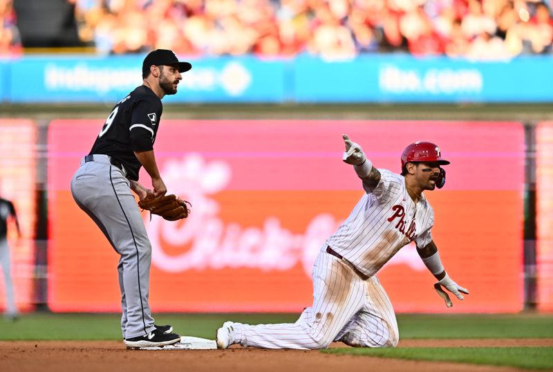 Apr 20, 2024; Philadelphia, Pennsylvania, USA; Philadelphia Phillies outfielder Nick Castellanos (8) reacts after sliding in safely against Chicago White Sox shortstop Paul DeJong (29) in the fourth inning at Citizens Bank Park. Mandatory Credit: Kyle Ross-USA TODAY Sports