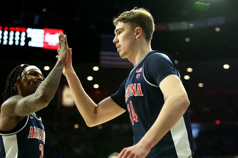 Jan 17, 2024; Tucson, Arizona, USA; Arizona Wildcats center Motiejus Krivas (14) celebrates with guard Caleb Love (2) after a defensive block against the USC Trojans during the first half at McKale Center. Mandatory Credit: Zachary BonDurant-USA TODAY Sports