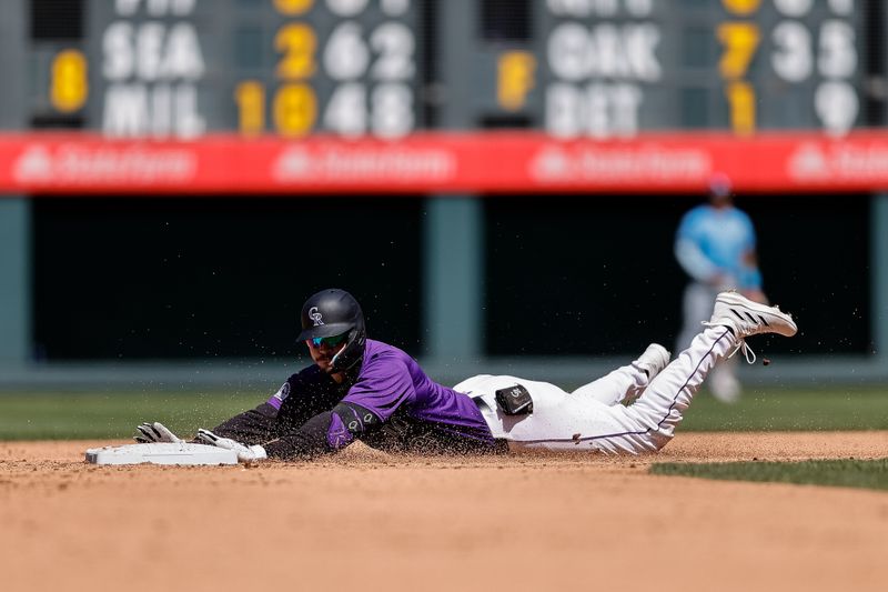 Apr 7, 2024; Denver, Colorado, USA; Colorado Rockies center fielder Brenton Doyle (9) slides into second on a double in the fifth inning against the Tampa Bay Rays at Coors Field. Mandatory Credit: Isaiah J. Downing-USA TODAY Sports