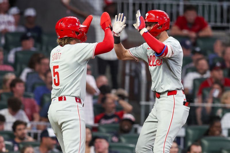 Jul 5, 2024; Atlanta, Georgia, USA; Philadelphia Phillies shortstop Trea Turner (7) celebrates with designated hitter Bryson Stott (5) after a two-run home run against the Atlanta Braves in the sixth inning at Truist Park. Mandatory Credit: Brett Davis-USA TODAY Sports