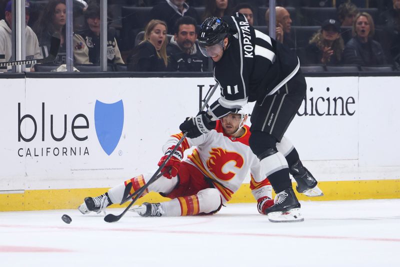 Dec 23, 2023; Los Angeles, California, USA; Los Angeles Kings center Anze Kopitar (11) skates for the puck against the Calgary Flames during the first period at Crypto.com Arena. Mandatory Credit: Jessica Alcheh-USA TODAY Sports