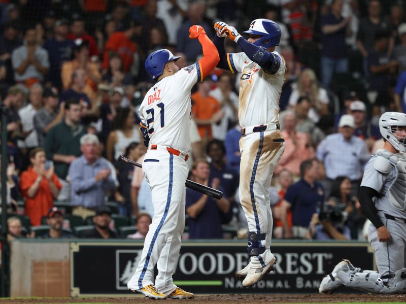 Apr 28, 2025; Houston, Texas, USA; Houston Astros first baseman Christian Walker (8) celebrates with catcher Yainer Diaz (21) after hitting a home run during the fourth inning against the Detroit Tigers at Daikin Park. Mandatory Credit: Troy Taormina-Imagn Images