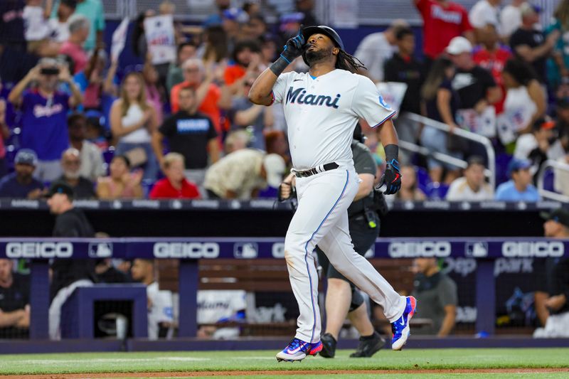 Sep 24, 2023; Miami, Florida, USA; Miami Marlins first baseman Josh Bell (9) reacts on his way to home plate after hitting a home run against the Milwaukee Brewers during the third inning at loanDepot Park. Mandatory Credit: Sam Navarro-USA TODAY Sports